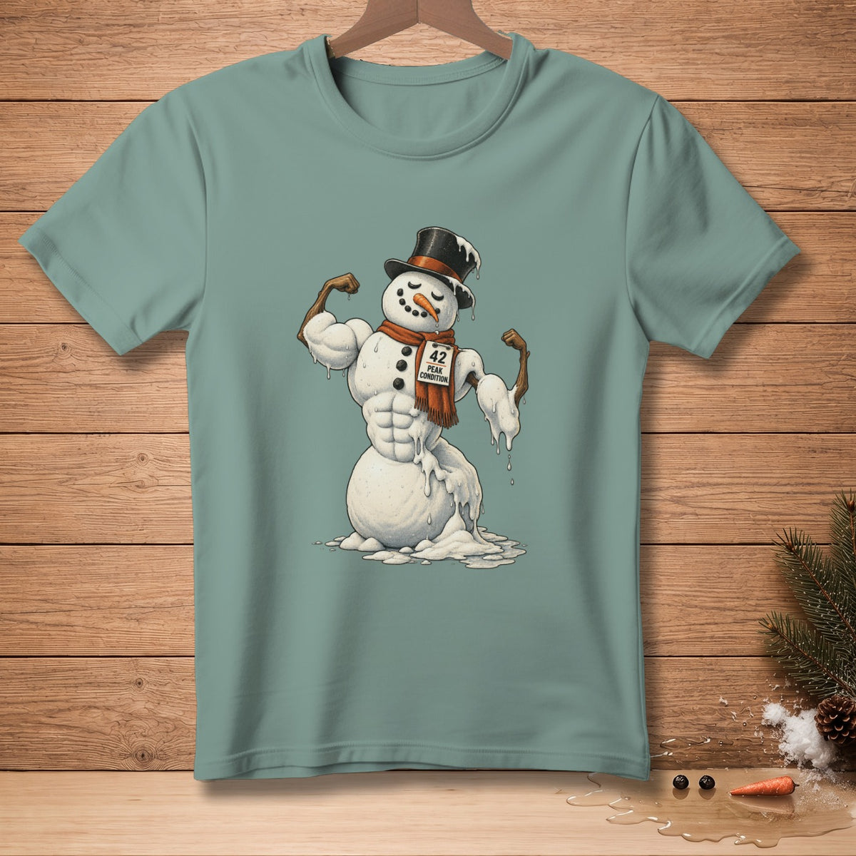 Snowman with muscular physique, hat, and scarf, on a teal t-shirt.