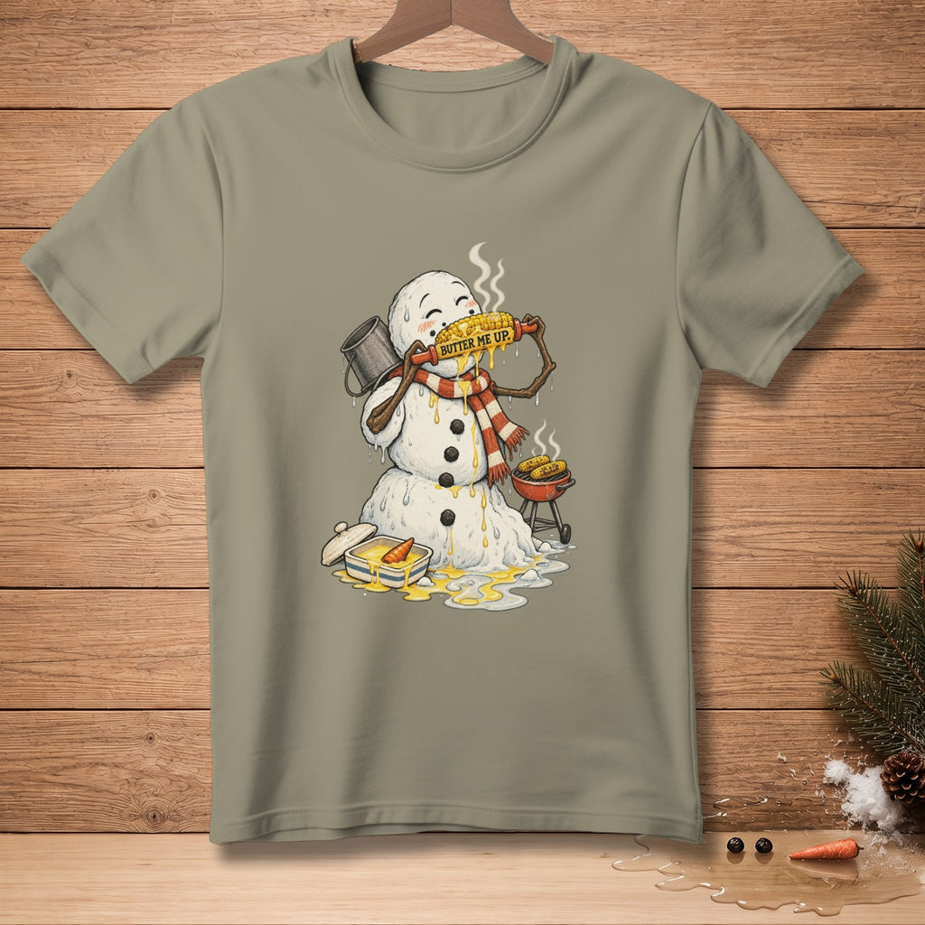 Snowman with scarf eating buttered corn on the cob, "Butter Me Up" text.