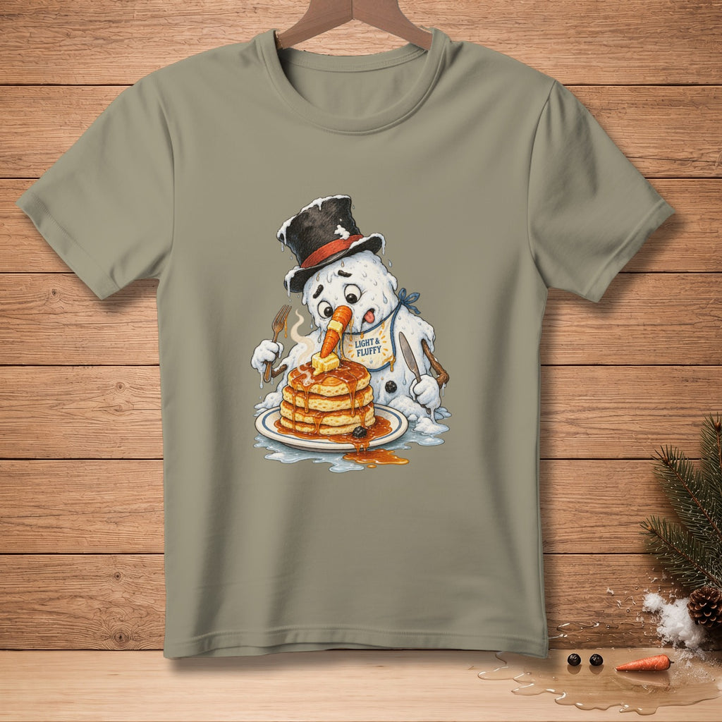 Melting snowman with a carrot nose eating pancakes wearing a bib that says "Light & Fluffy".