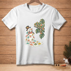 Snowman with tiny umbrellas surrounded by melting snow and a chameleon on a branch.