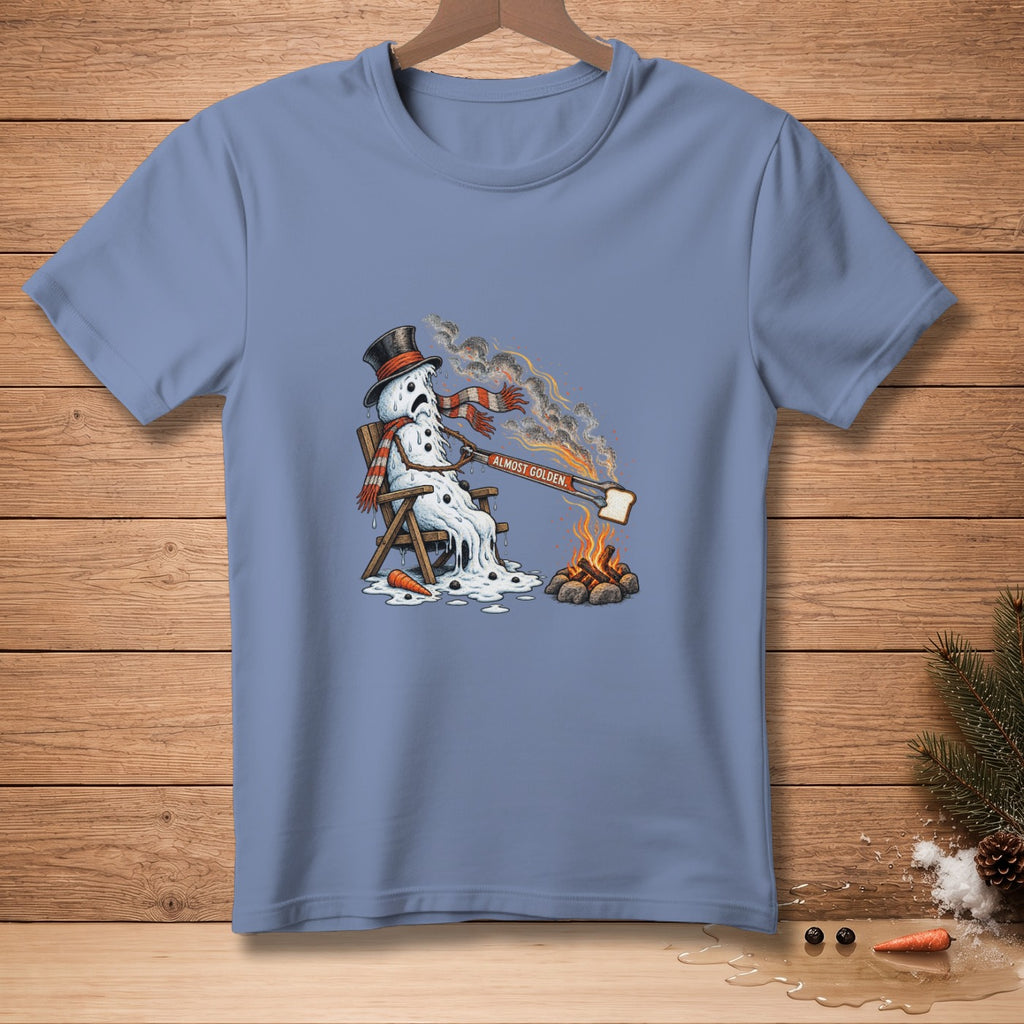 Melting snowman in lounge chair with toast over campfire, text "ALMOST GOLDEN."