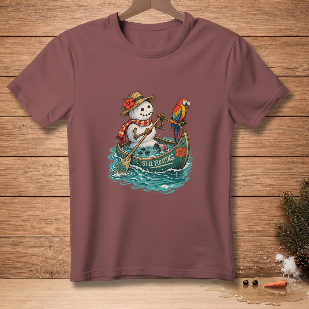 Snowman in a canoe with a parrot, text reads "Still Floating."