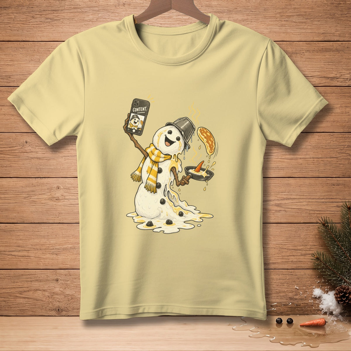 Melting snowman taking a selfie with a pancake in a frying pan.