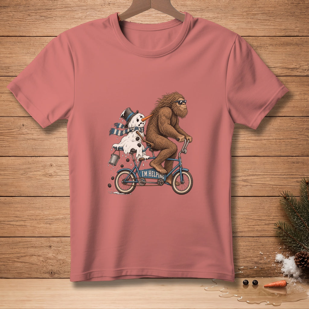 Bigfoot and a melting snowman ride a bicycle with "I'M HELPING" written on it.