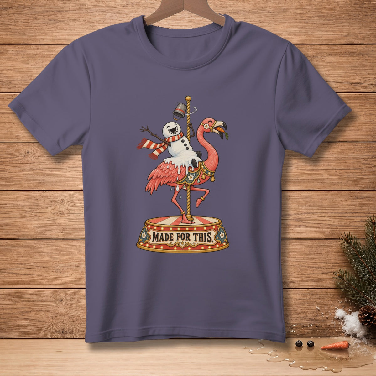 T-shirt with a flamingo and snowman riding a carousel, "MADE FOR THIS" text.