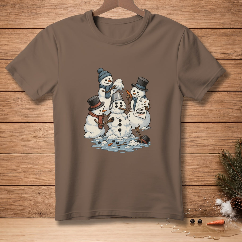 Snowmen building a snowman with a sign that says "CLOSE ENOUGH".