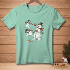 Three snowmen are playing with a red ball and carrots on a light teal t-shirt.