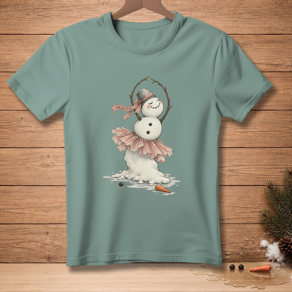 Snowman in ballerina tutu and top hat with "Graceful" banner on teal t-shirt.