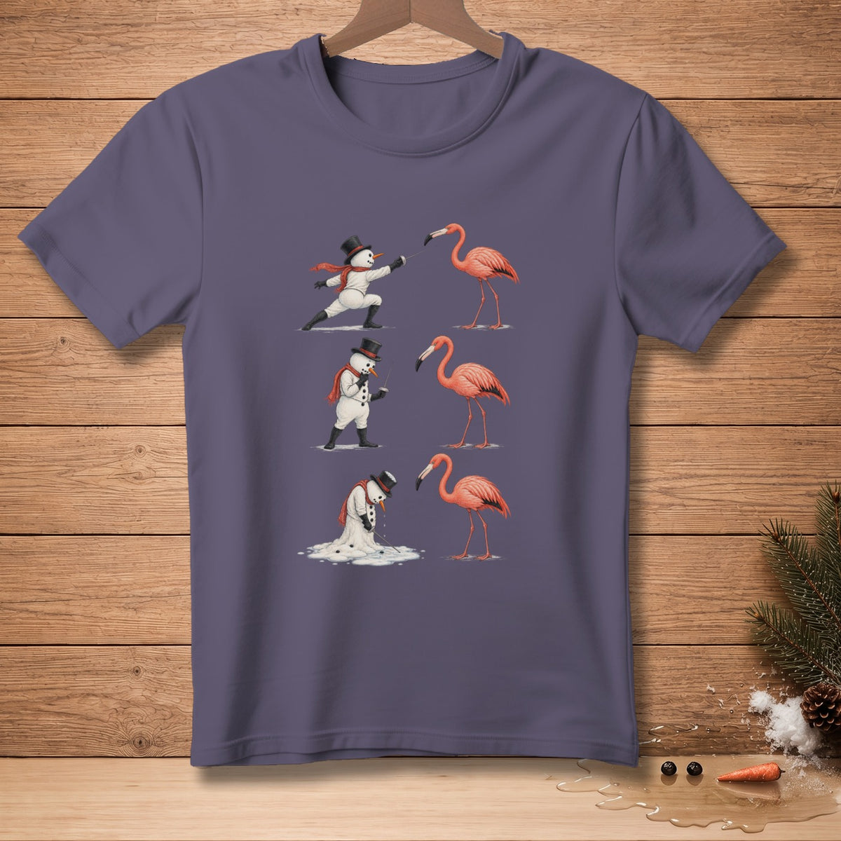 T-shirt with a graphic of snowmen fencing with flamingos, one melting.