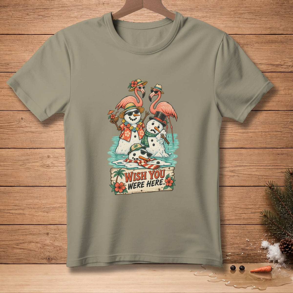 Snowmen in hats and sunglasses with flamingos in water, "Wish You Were Here" text.