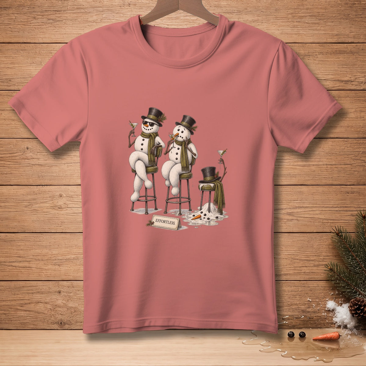 T-shirt with two snowmen holding drinks and a melting snowman with the text "EFFORTLESS".