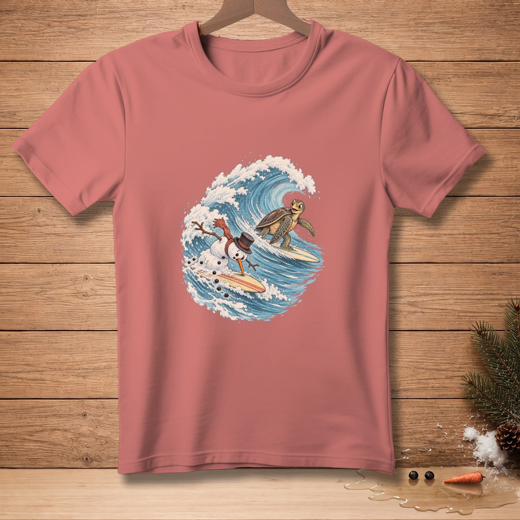 Salmon pink t-shirt featuring a cartoon snowman and turtle surfing on a wave.