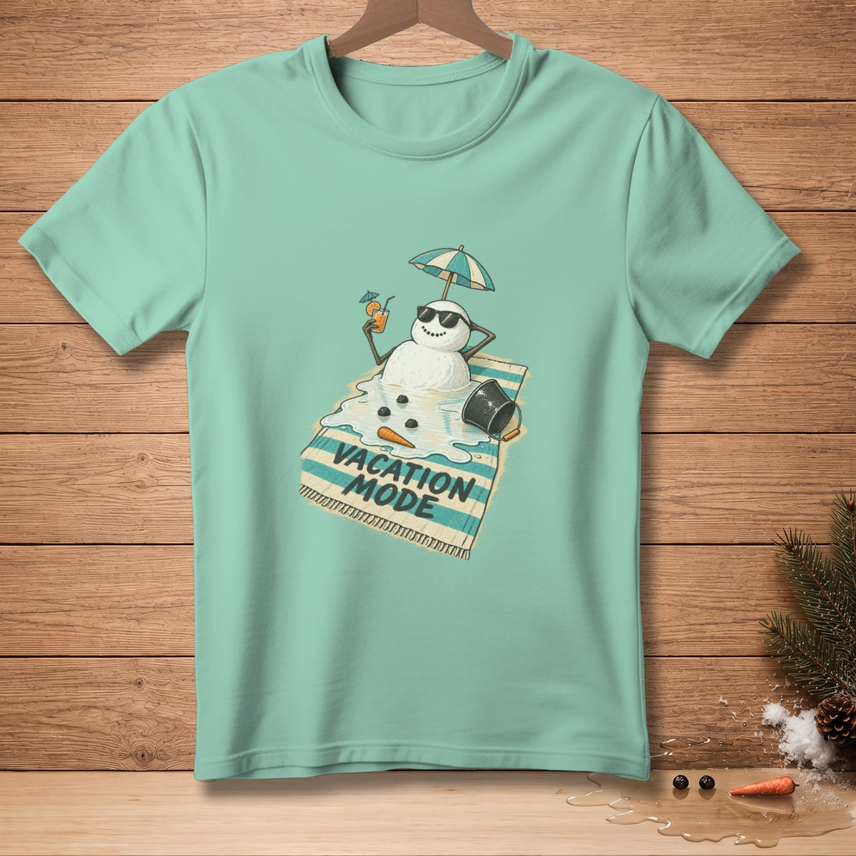 T-shirt graphic: melting snowman on beach towel with "Vacation Mode" text.