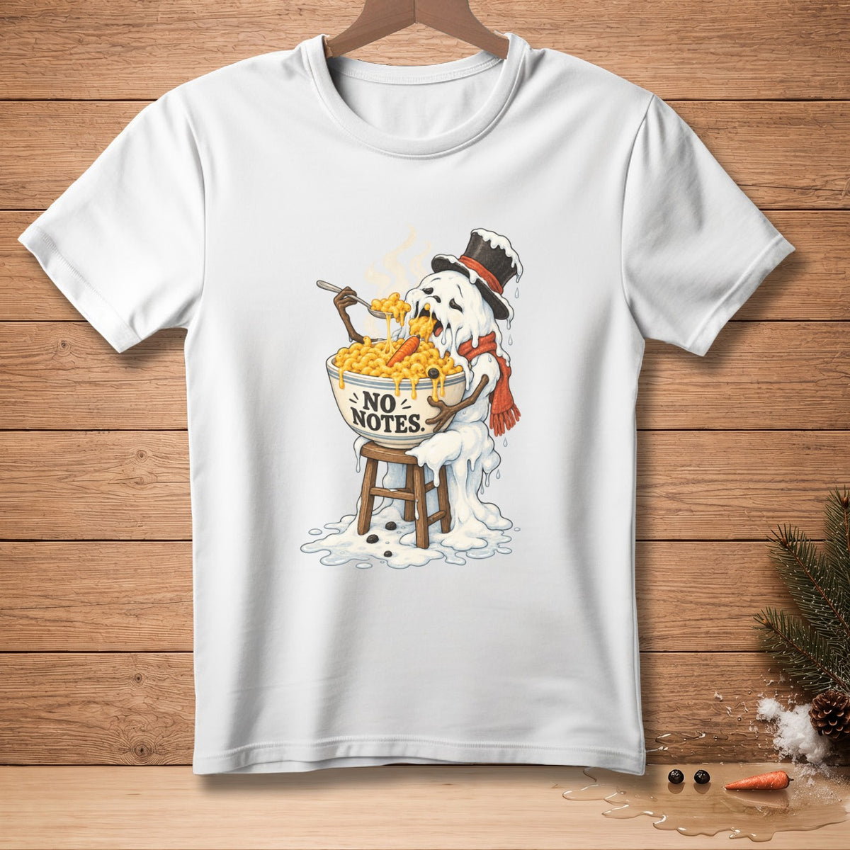 White t-shirt graphic: melting snowman eating mac and cheese, "NO NOTES."