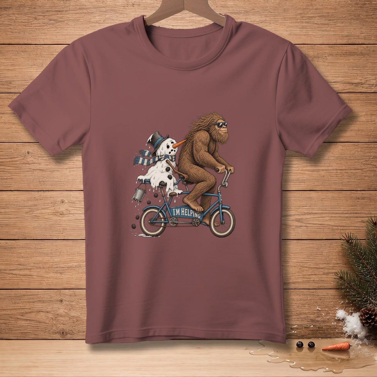 Bigfoot rides tandem bicycle with melting snowman and text "I'M HELPING".