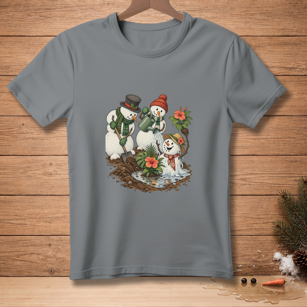 Three snowmen watering tropical plants, one with a shovel, on a gray t-shirt.