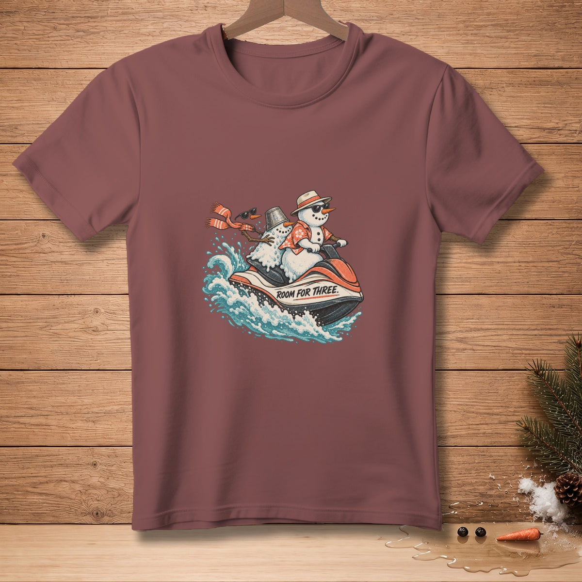 T-shirt graphic of two snowmen riding a jet ski with text "ROOM FOR THREE".