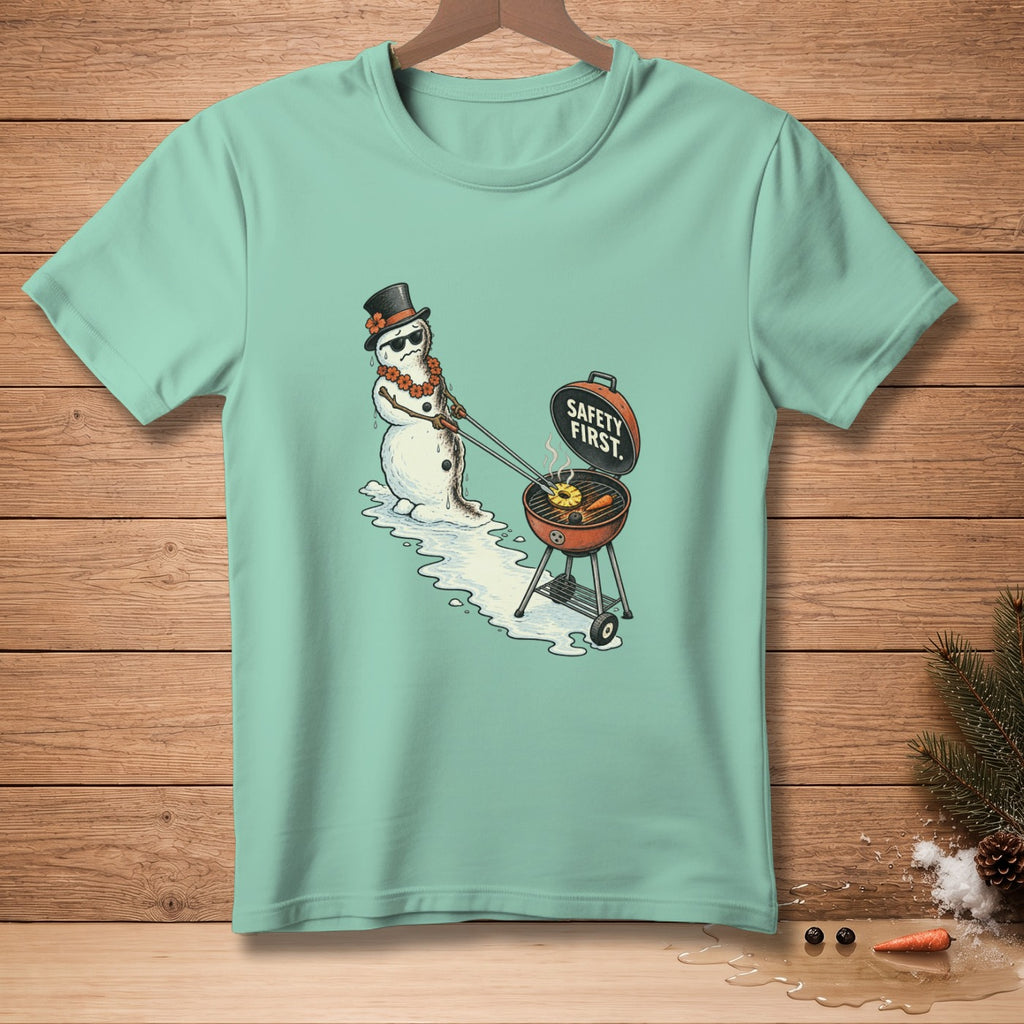 Snowman in top hat grilling pineapple and carrots, text "Safety First."
