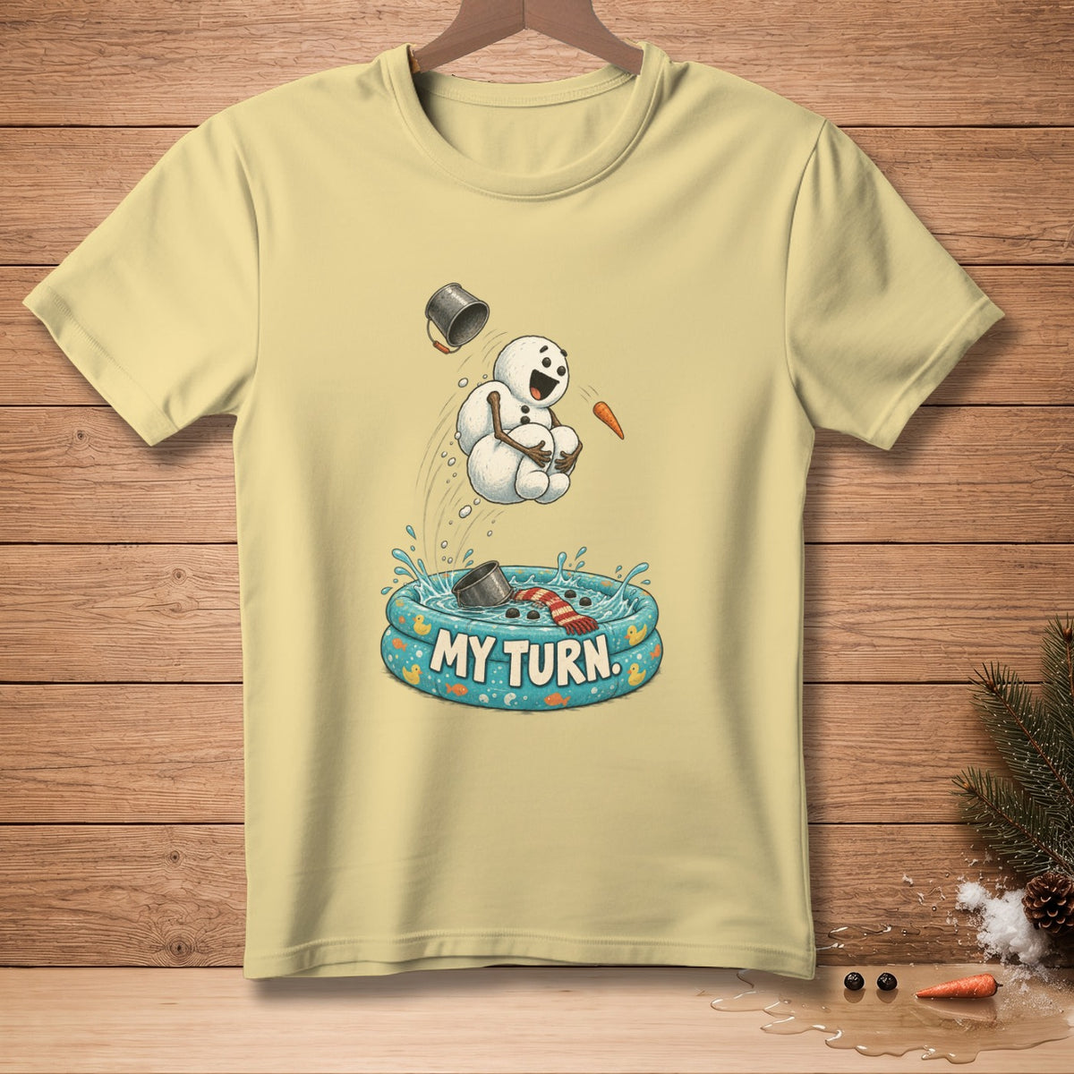 Light yellow t-shirt with a cartoon snowman jumping into a pool with "MY TURN" text.
