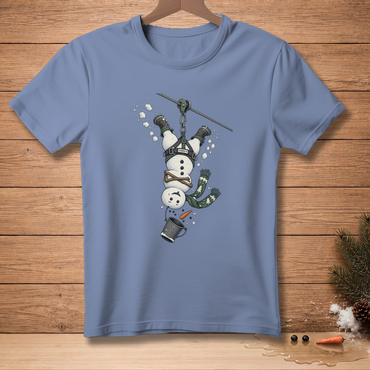 Snowman zip-lining upside down, wearing a harness and scarf, dropping a bucket.