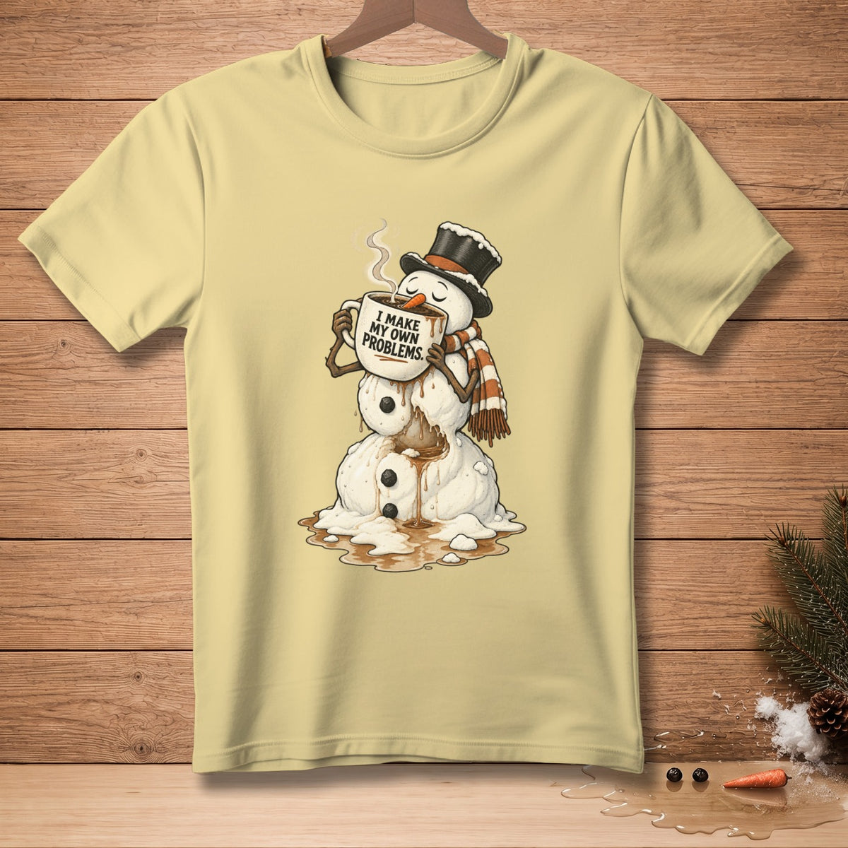 Snowman in top hat and scarf melting while holding mug that reads "I MAKE MY OWN PROBLEMS."