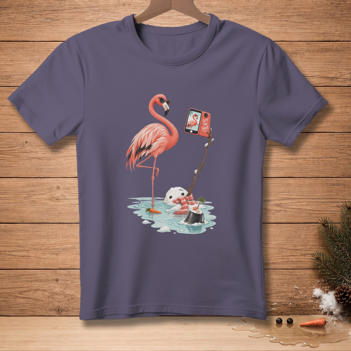 Flamingo wearing sunglasses takes selfie with melting snowman in puddle, text says "Got The Shot".