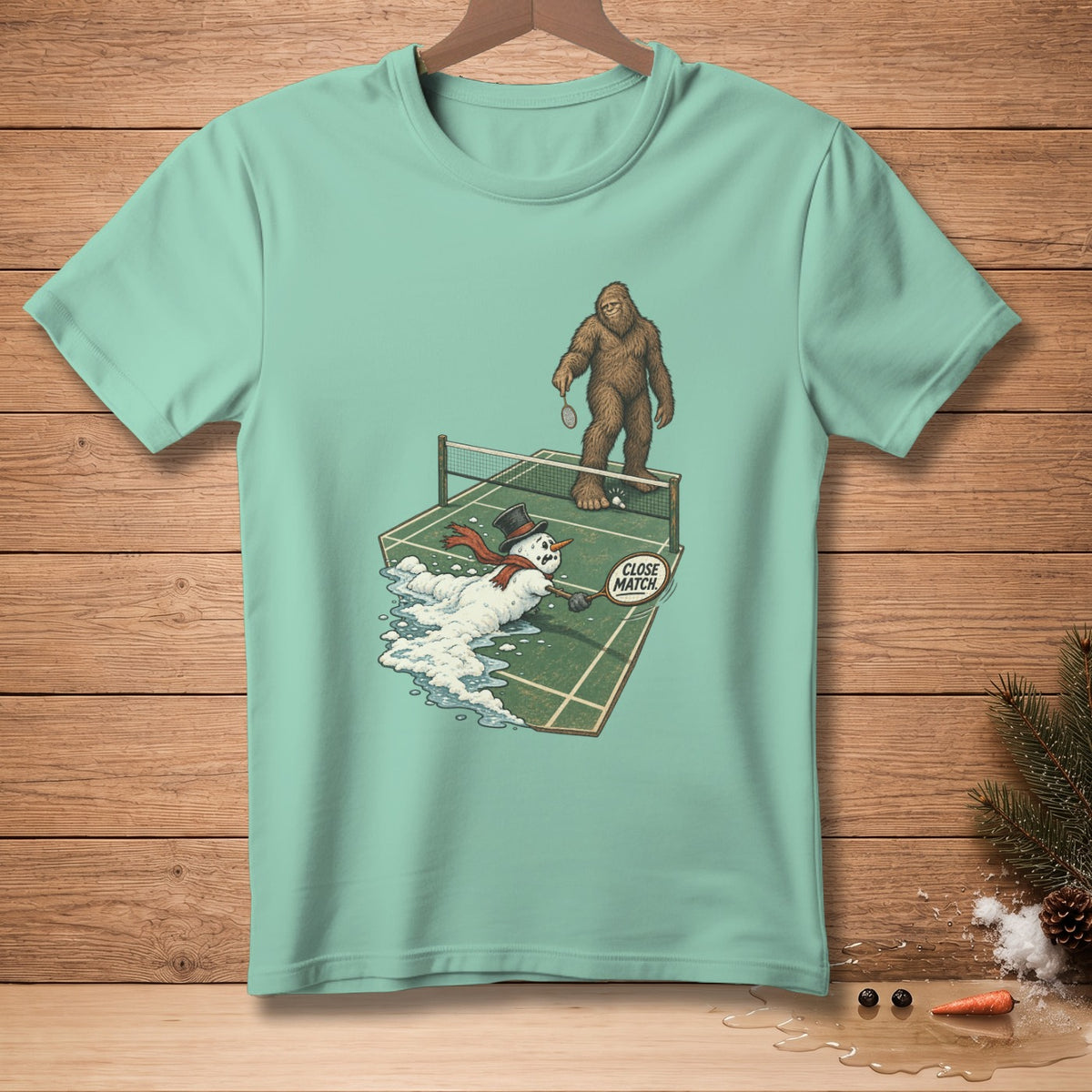 Bigfoot plays badminton against melting snowman with "Close Match" sign.