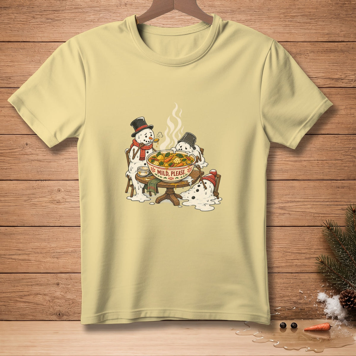 Yellow t-shirt with illustration of melting snowmen eating a bowl of soup with text "MILD, PLEASE."