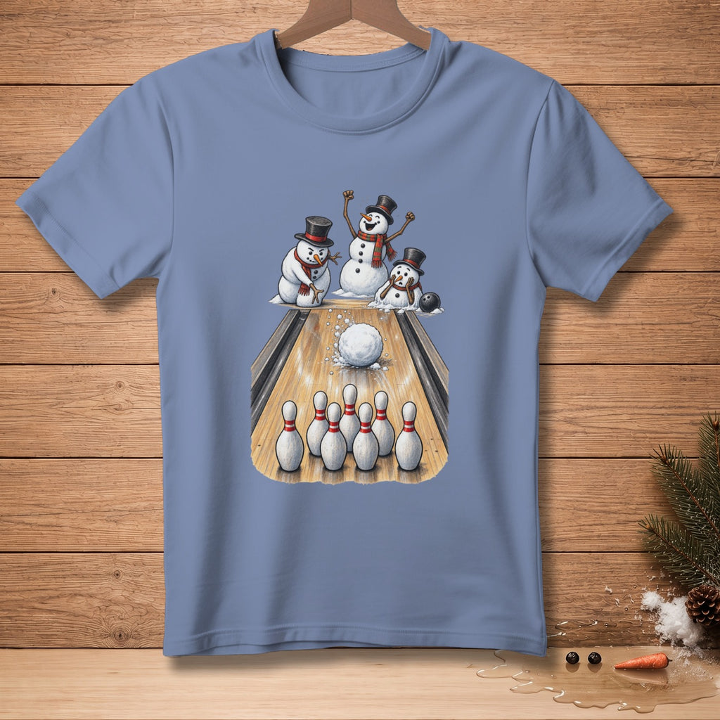 T-shirt graphic of snowmen bowling with a snowball and pins on a wooden lane.