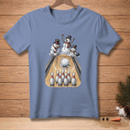 T-shirt graphic of snowmen bowling with a snowball and pins on a wooden lane.