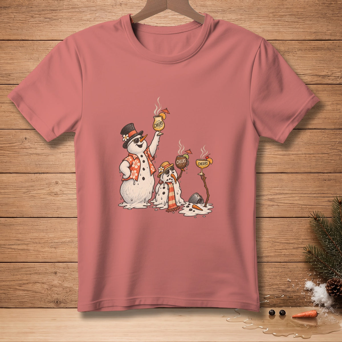 T-shirt with melting snowmen holding "Cheers" drinks on a wooden background.