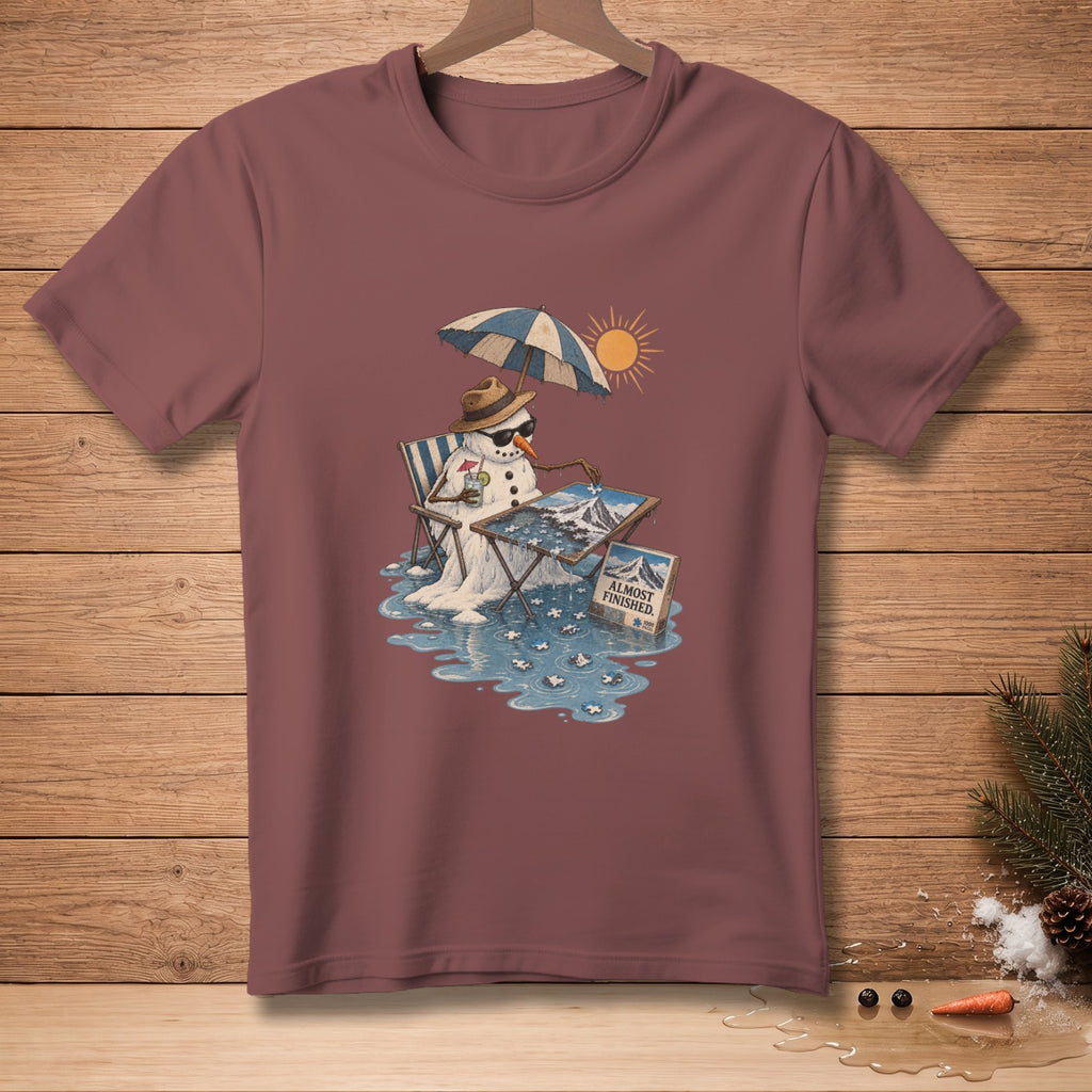 Melting snowman in a beach chair, assembling a puzzle, with text "Almost Finished."