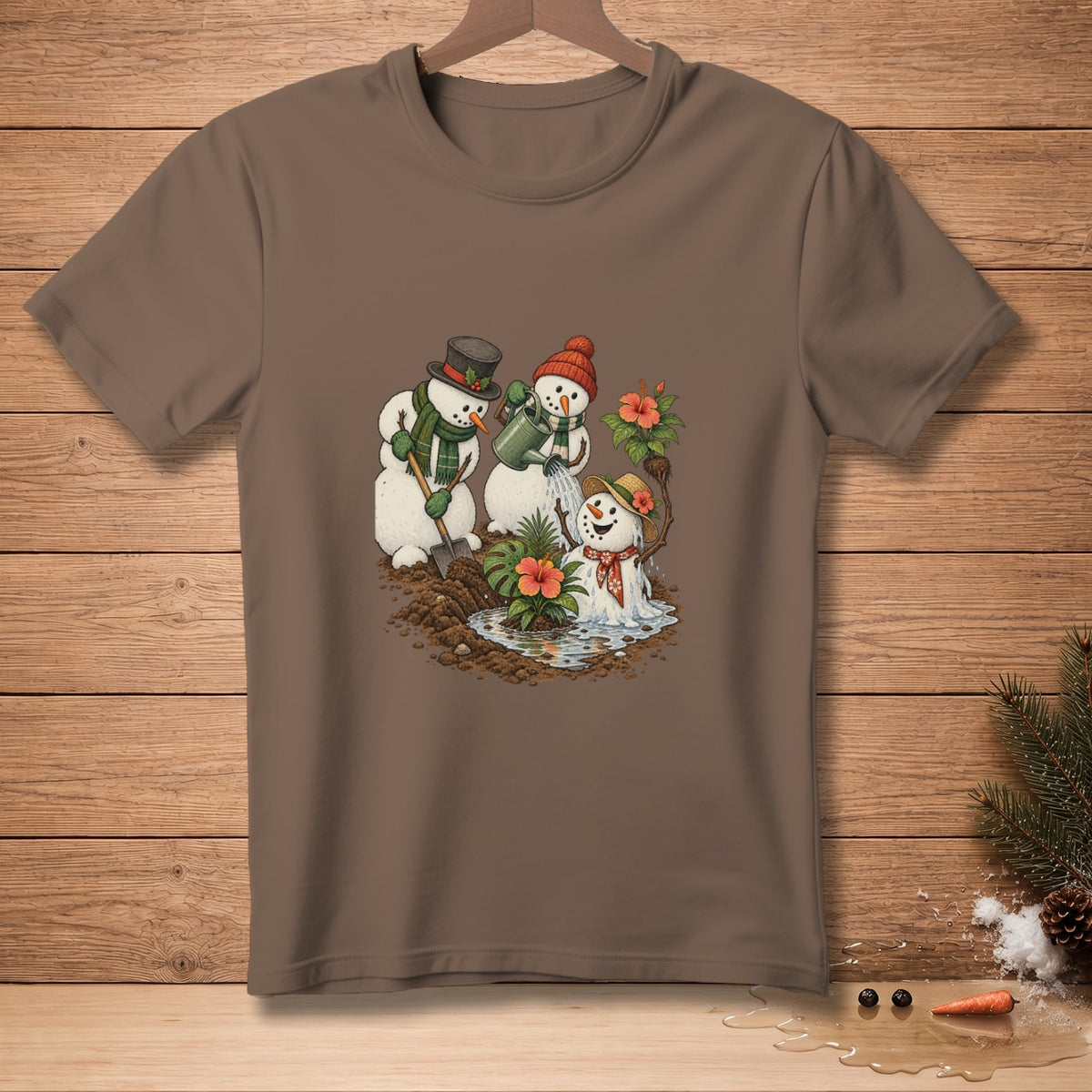Brown t-shirt with snowmen gardening with tropical flowers and a watering can.