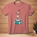 Pink t-shirt with a comical illustration of a melting snowman falling into a snow tube.