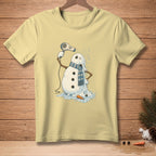 Light yellow t-shirt with melting snowman using a hairdryer, text reads "ALMOST DRY".