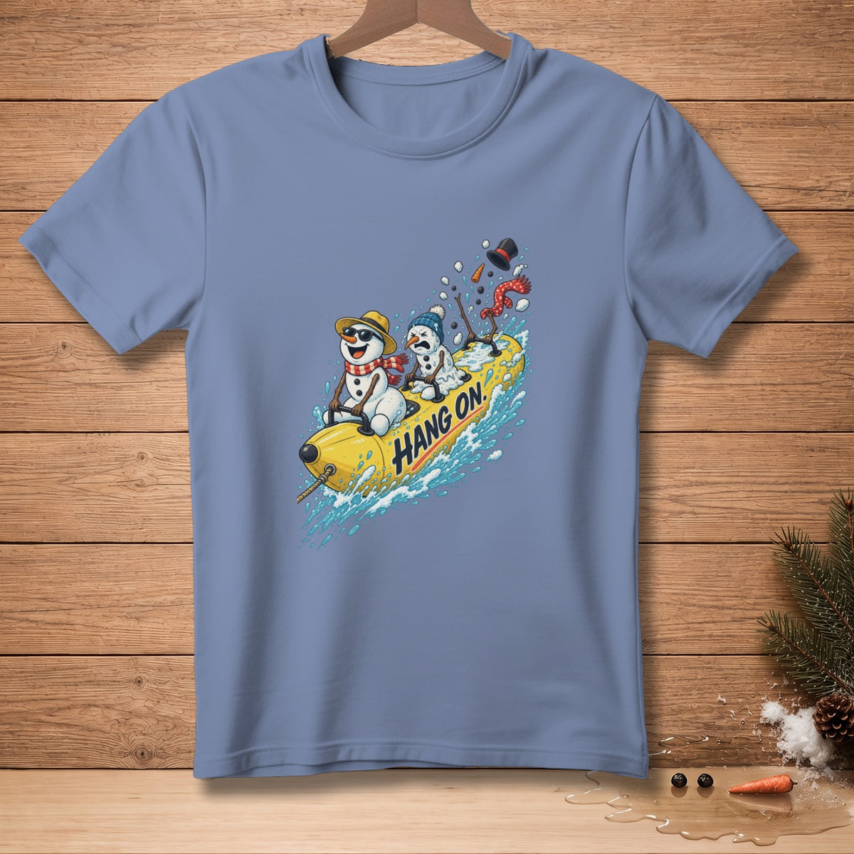 Blue t-shirt with cartoon snowmen on a banana boat, "Hang On." text.