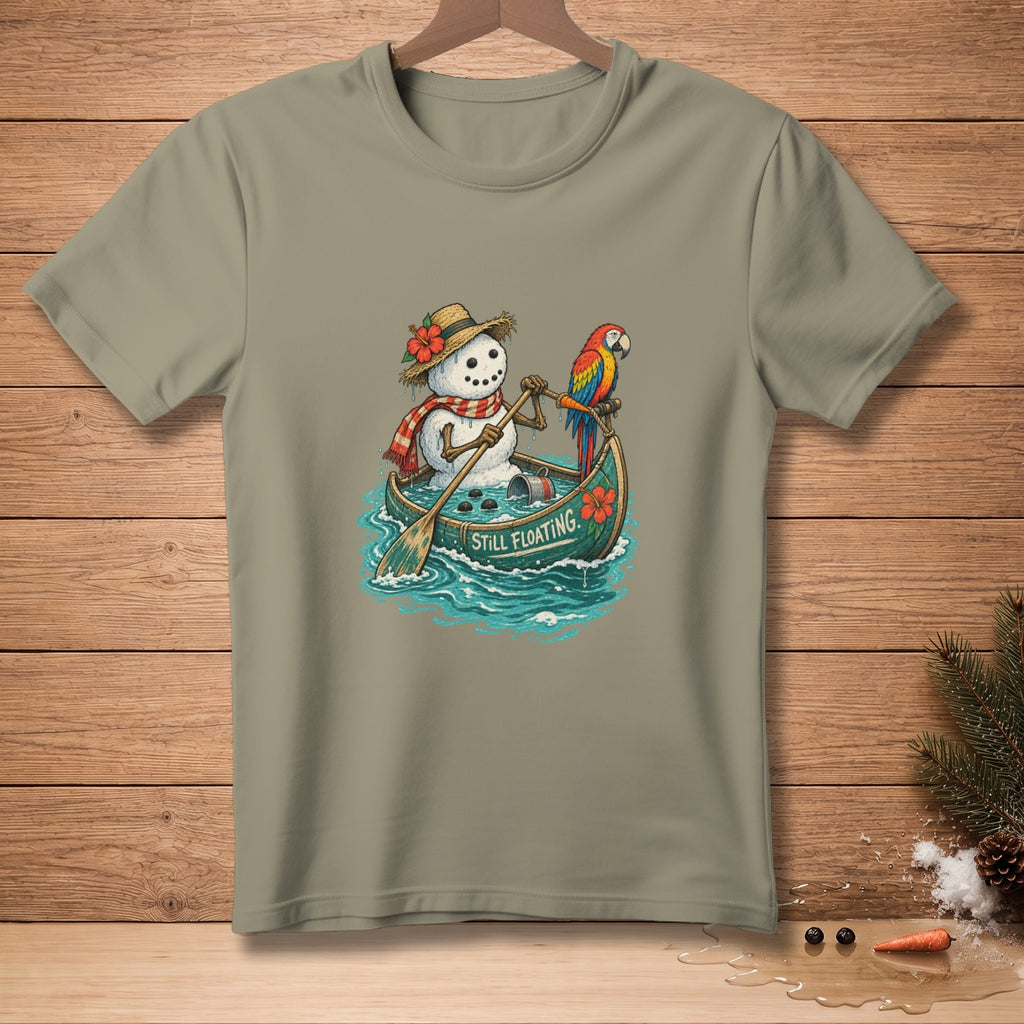 Snowman in a canoe with a parrot, text reads "STILL FLOATING".
