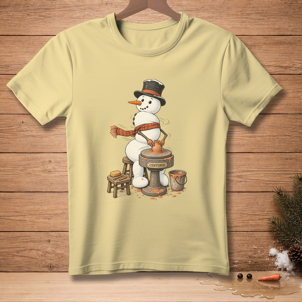 Snowman wearing a top hat and scarf, working on a pottery wheel with the word "CENTERED" on the base.
