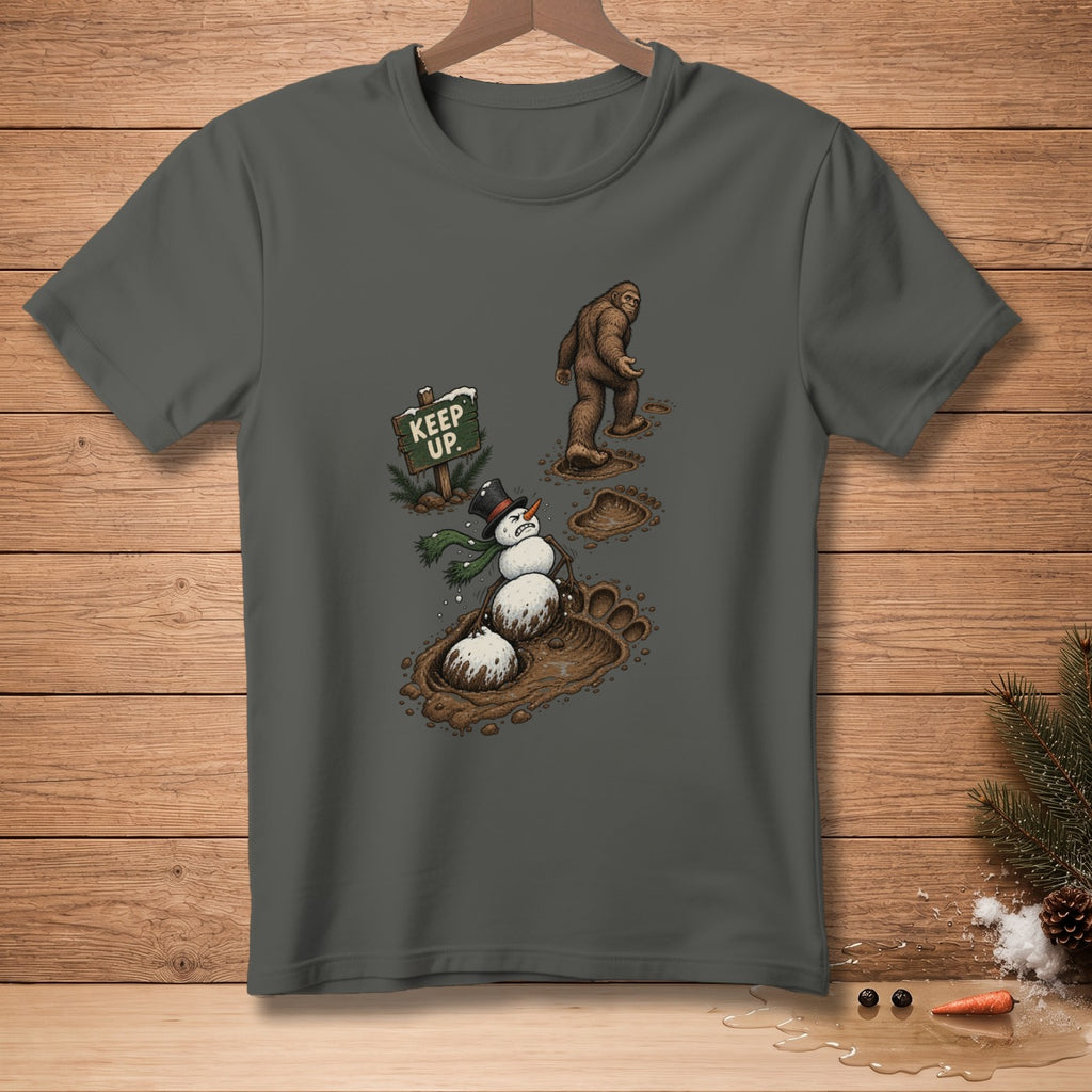 Bigfoot stands over a melting snowman in muddy footprints, with a "Keep Up" sign.