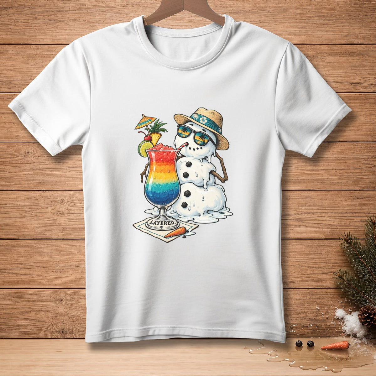 White t-shirt with melting snowman wearing sunglasses and drinking a rainbow cocktail.