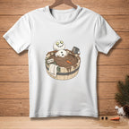 White t-shirt with a cartoon snowman relaxing in a wooden tub labeled "Detox."