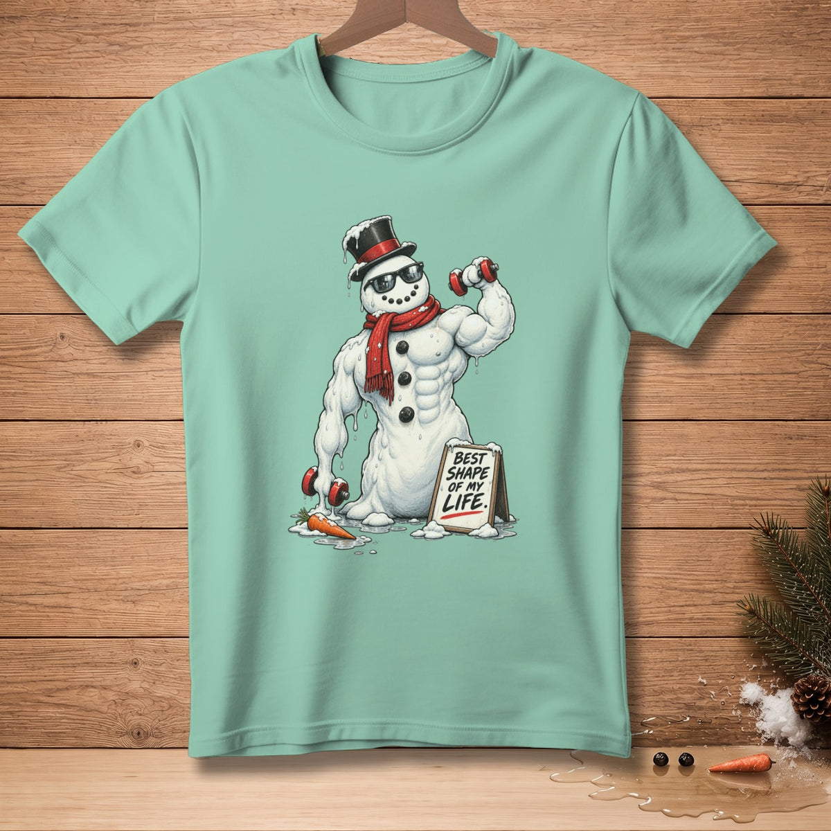 Shirt with muscular snowman lifting weights, wearing a top hat and scarf.