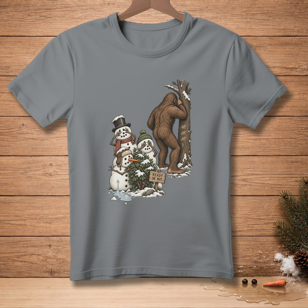 Bigfoot hiding behind tree near snowmen playing hide-and-seek; sign says "READY OR NOT."