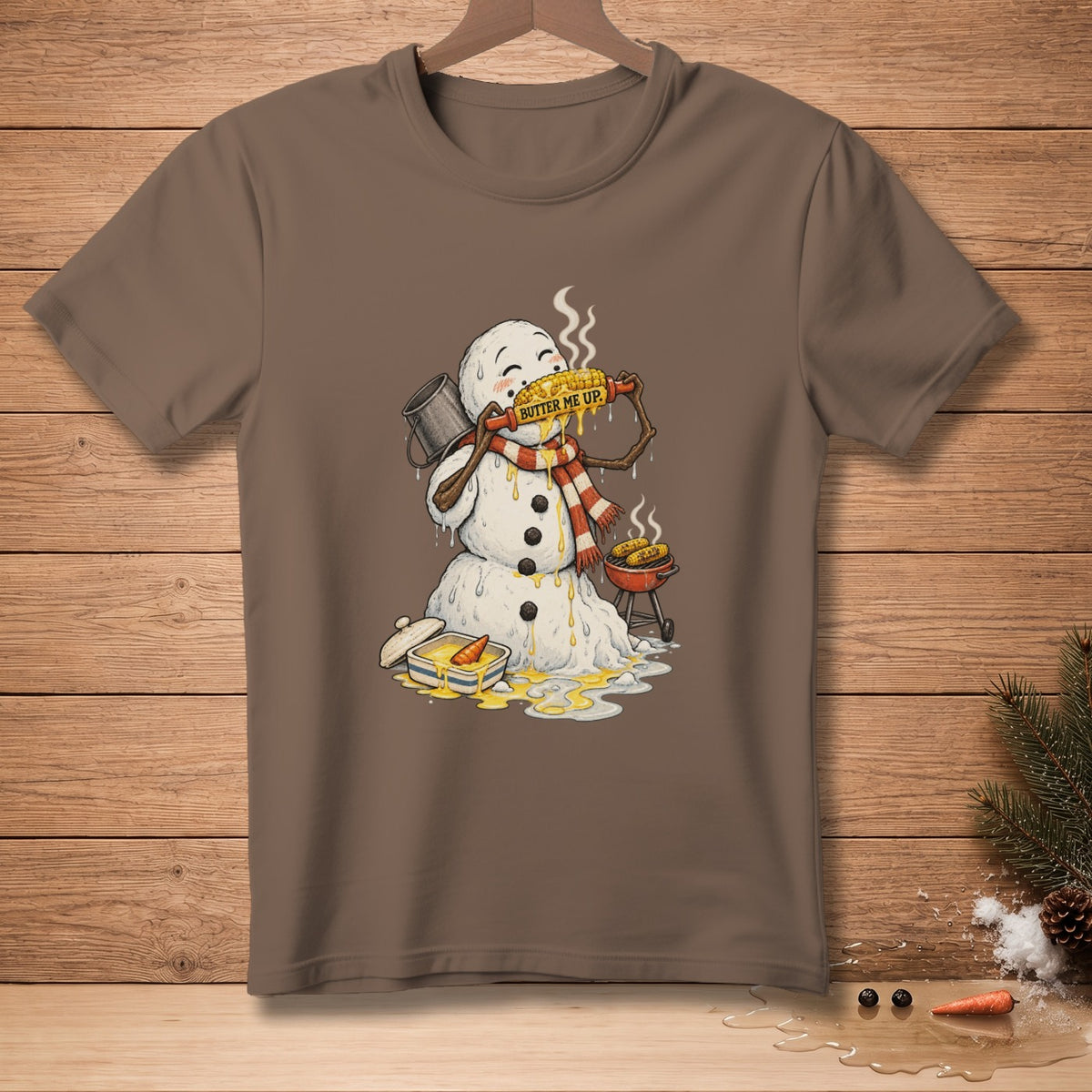 Snowman eating buttered corn on the cob, with a grill and butter dish.