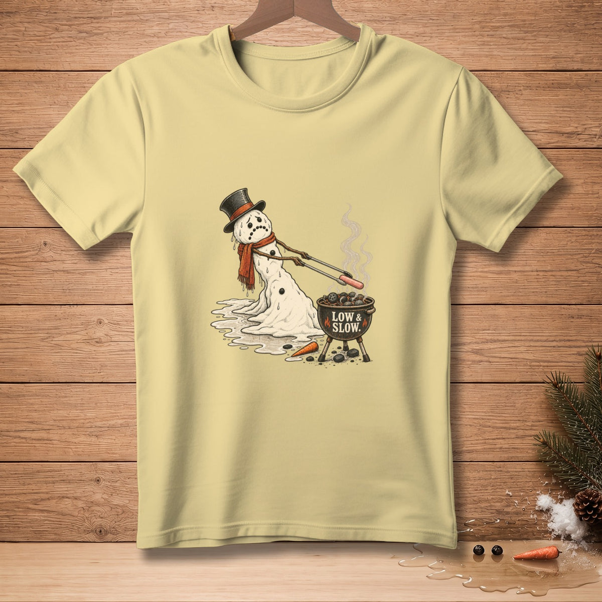 Melting snowman with hat grilling hot dogs and text "LOW & SLOW".