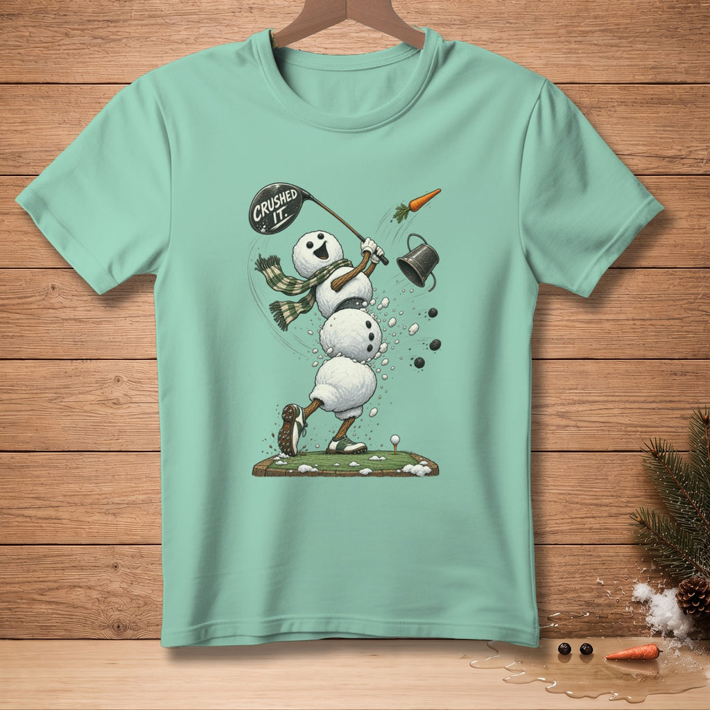 Snowman golfer mid-swing, "Crushed It" on club, carrot flying, on a mint t-shirt.