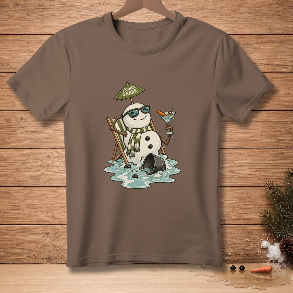 Melting snowman in sunglasses relaxes in a chair with a drink under an umbrella that reads "Found Shade".