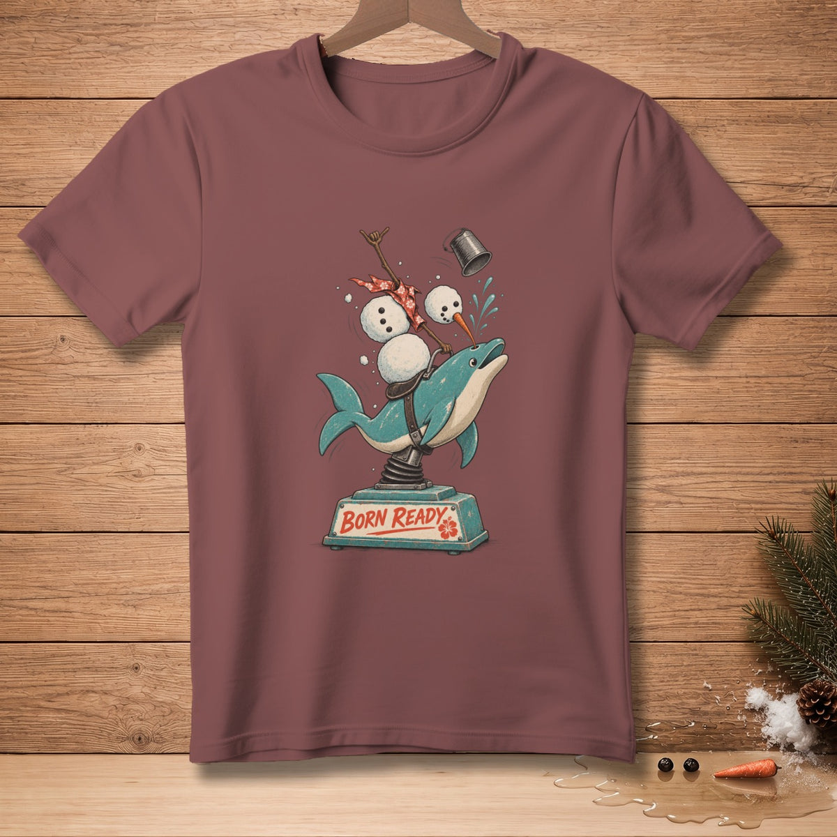Dolphin with snowmen and text "BORN READY" on a maroon t-shirt.