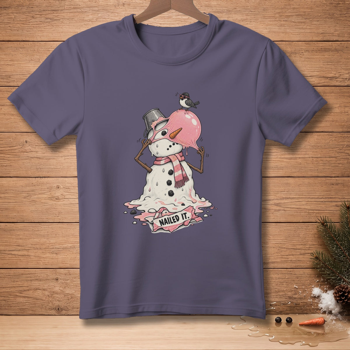 T-shirt with a melting snowman illustration that says "Nailed It."