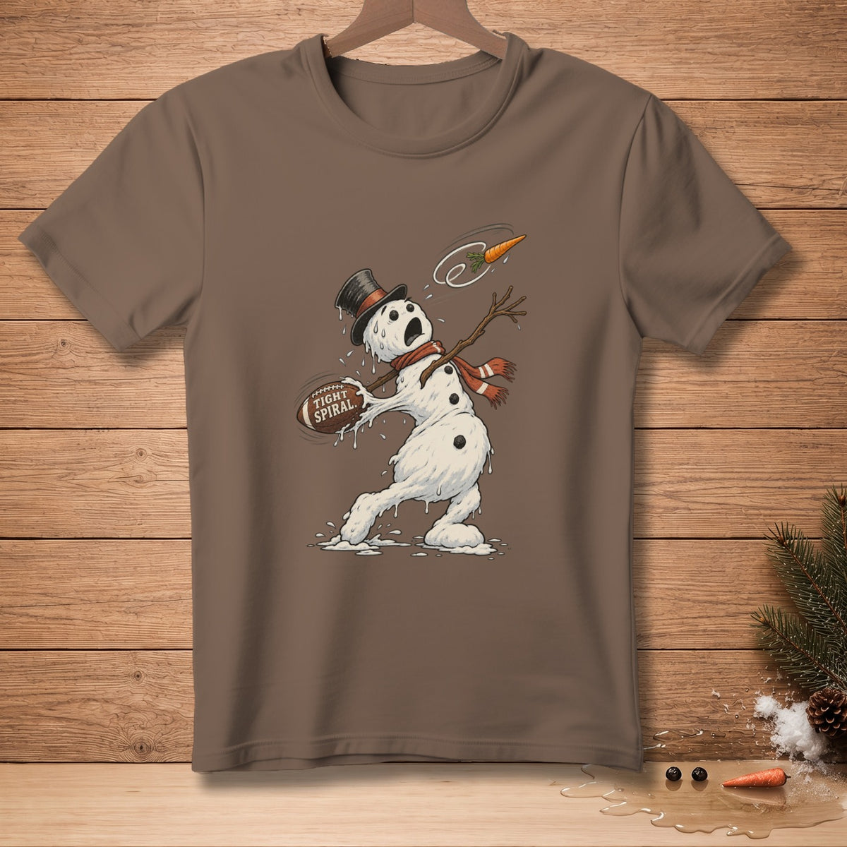Brown t-shirt with melting snowman catching a football labeled "Tight Spiral".